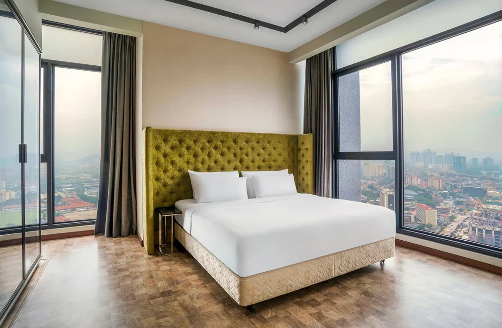 Luxury hotel room at Expressionz Professional Suites with panoramic city view.
