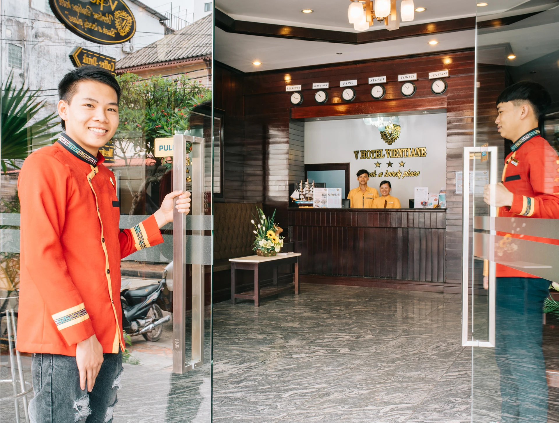 Hotel receptionist welcoming guests at V Hotel Vientiane