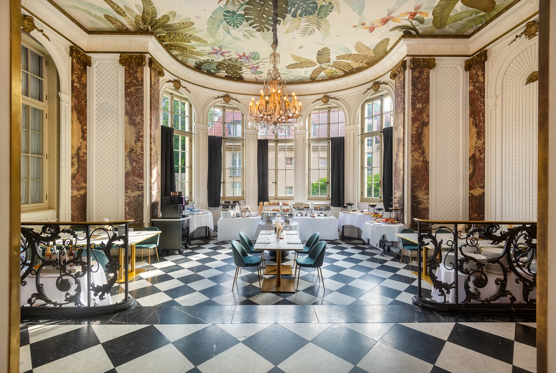 Luxurious hotel dining room with chandeliers and breakfast buffet