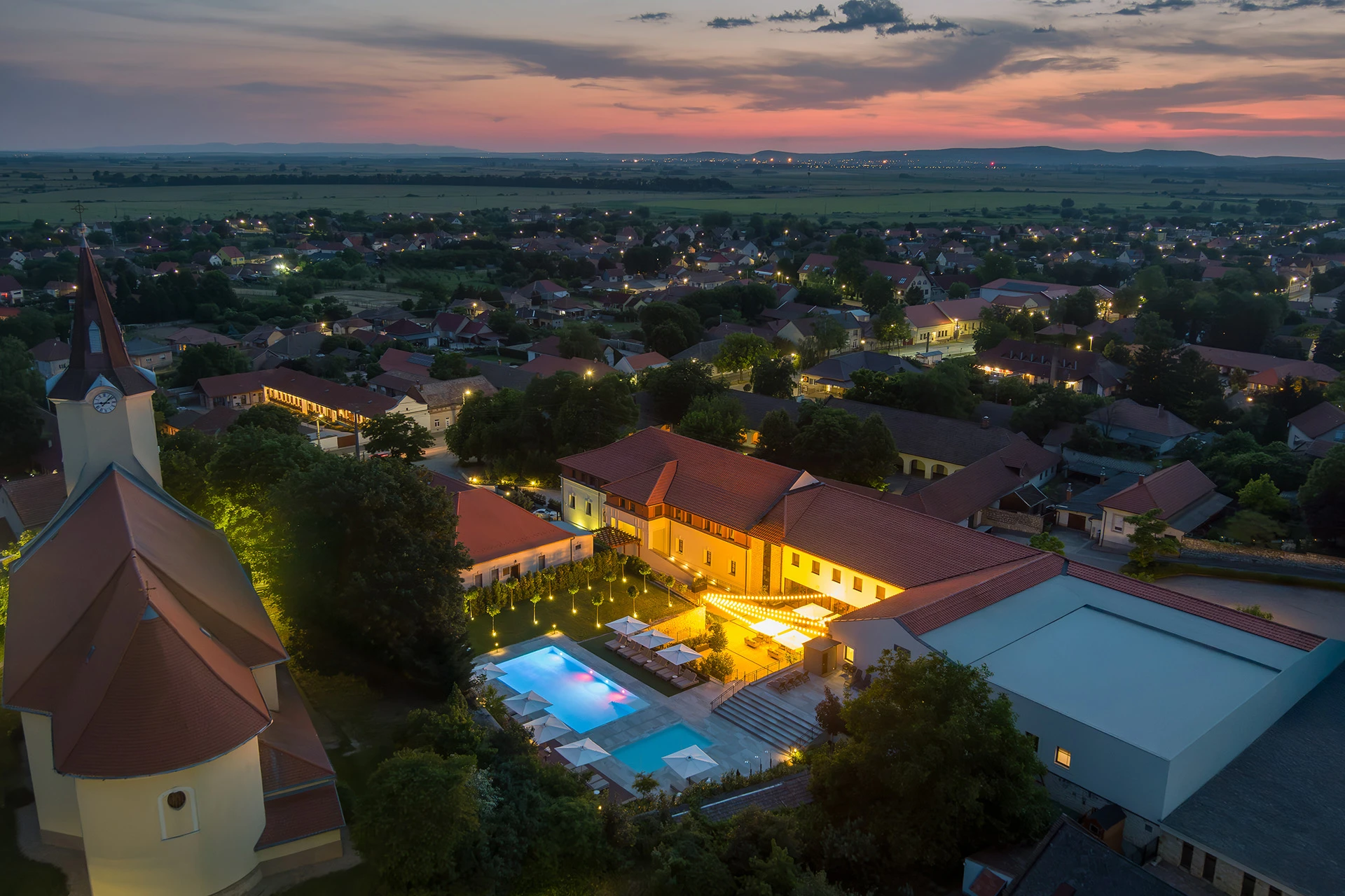 Aerial view of luxury hotel exterior at sunset