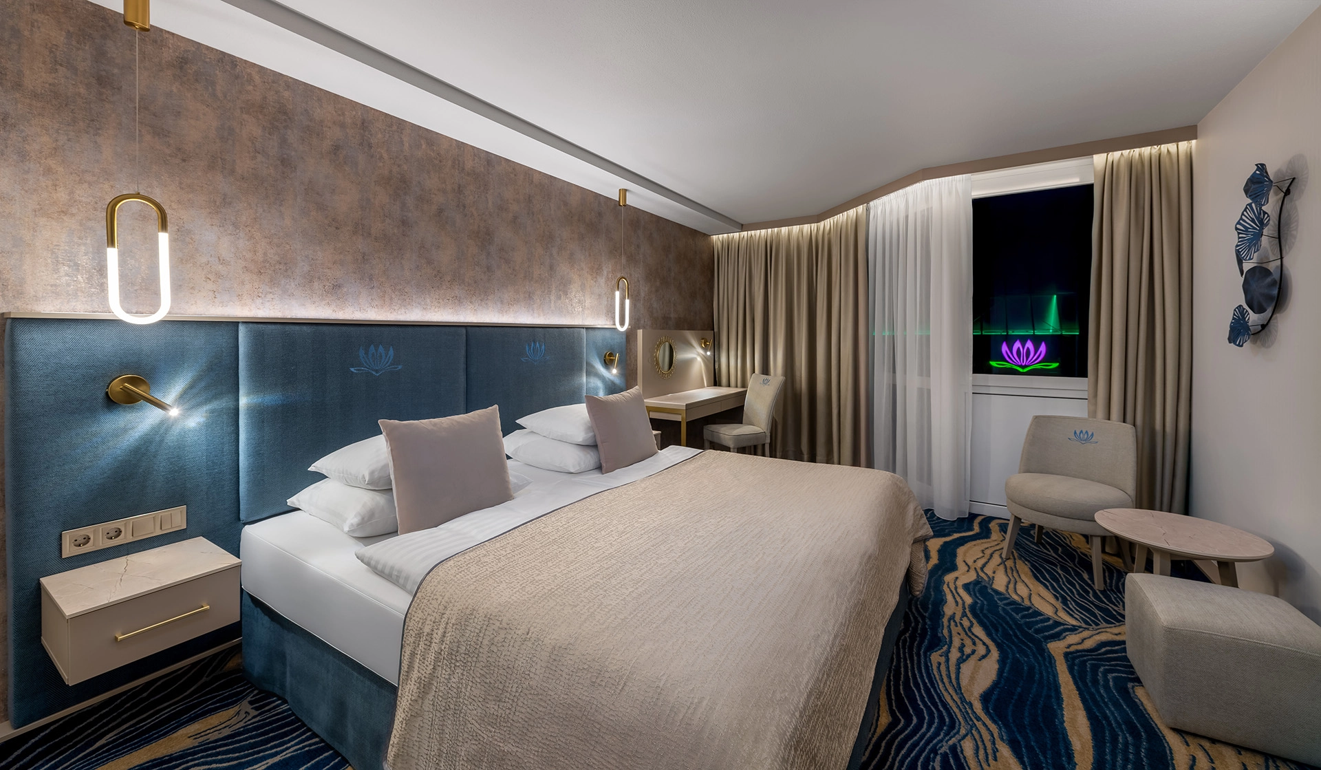 Modern hotel room with illuminated logo visible through window