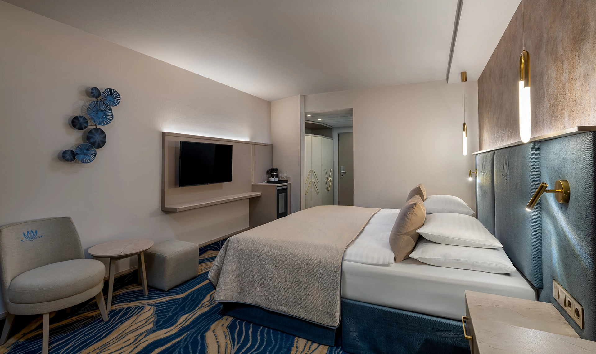 Minimalist hotel room with double bed and neutral tones