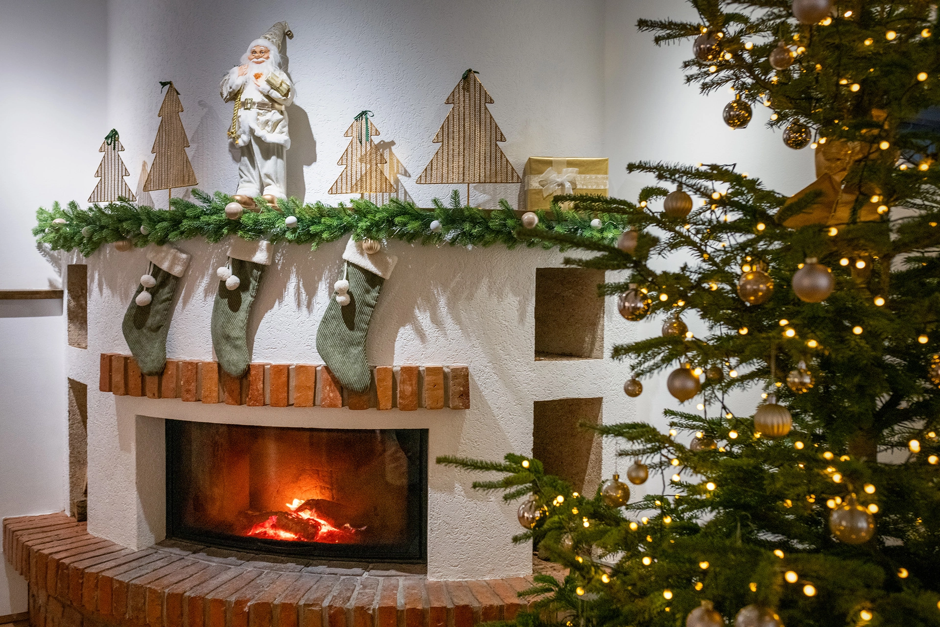 Hotel fireplace decorated with Christmas stockings and tree
