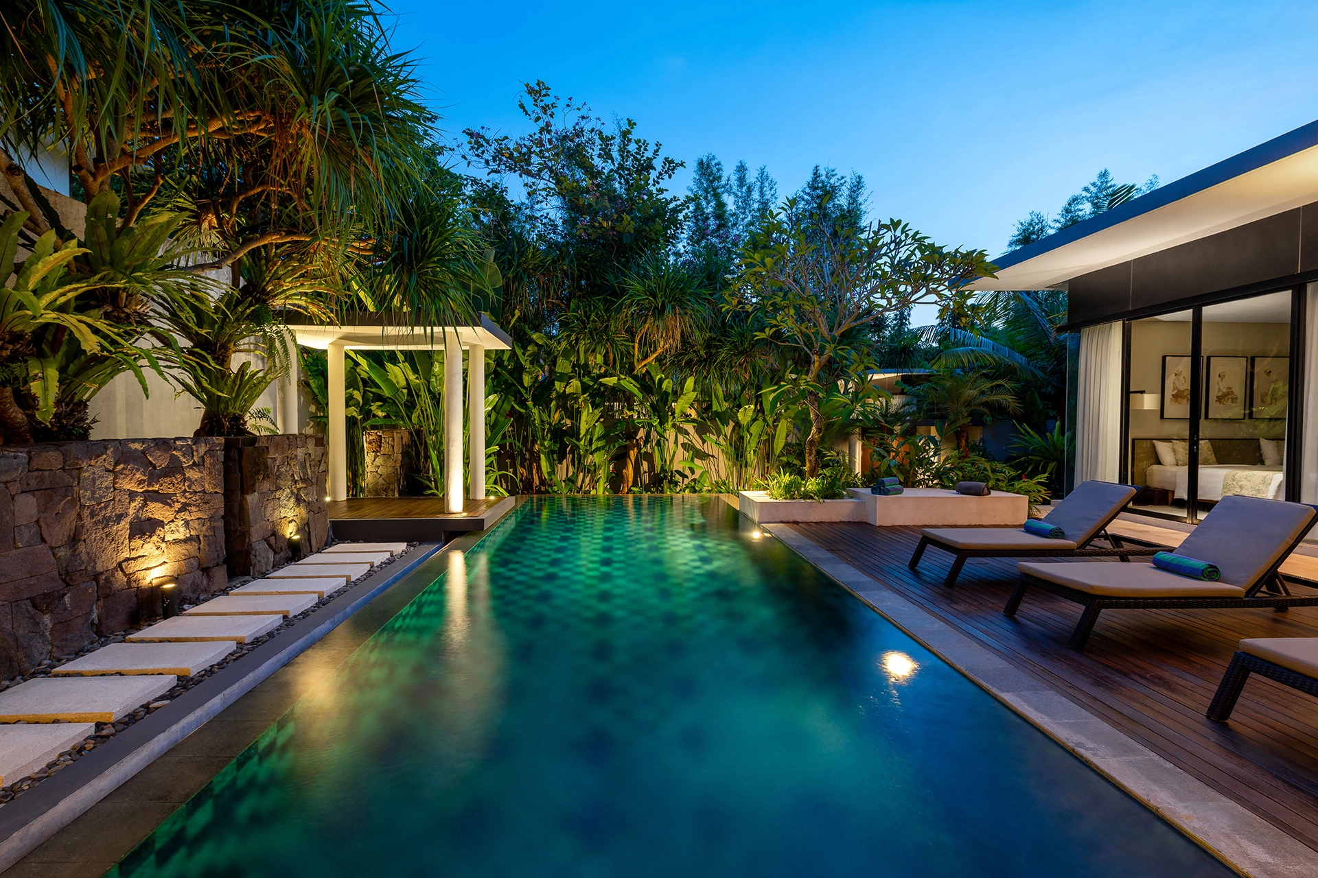 Luxury tropical pool villa at night in Bali